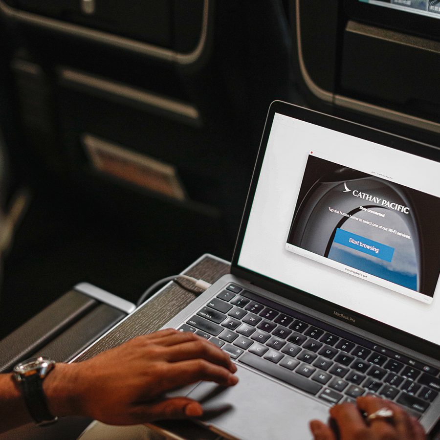 Person using inflight Wi-Fi to access the Cathay Pacific website